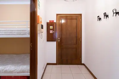 a room with a door and a bedroom with a bed at GuestReady - Modern 2BR Flat in Vila Nova de Gaia in Porto