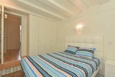 a white bedroom with a bed with two pillows at Duque - Guest House in Porto