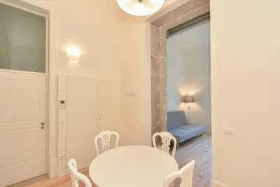 a white dining room with a white table and chairs at Duque - Guest House in Porto