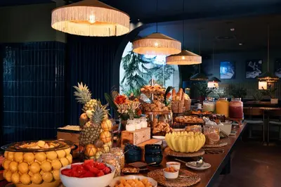 a buffet of food with fruits and vegetables on a table at chic&basic Gravity in Porto