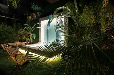 a pool with chairs and a plant in a yard at chic&basic Gravity in Porto