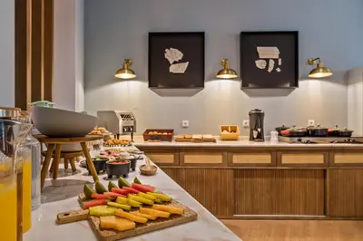 a restaurant with a buffet of food in a room at Pur Oporto Boutique Hotel by actahotels in Porto