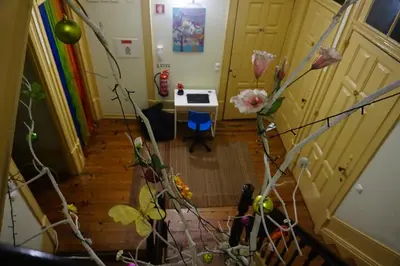 an overhead view of a room with a staircase with flowers at CoolHostel in Porto
