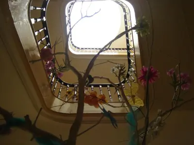 a mirror with flowers in front of a window at CoolHostel in Porto