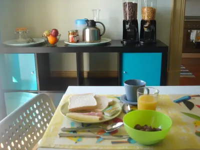 a table with a plate of food and a bowl of food at CoolHostel in Porto