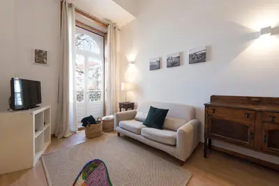 a living room with a couch and a tv at LovelyStay - The Porto Getaway Duplex - Free Parking in Porto