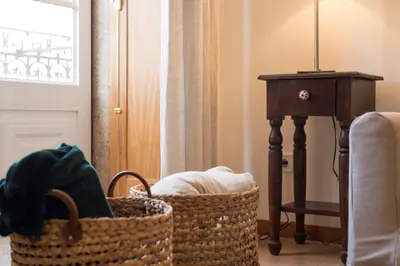a room with a basket and a table and a window at LovelyStay - The Porto Getaway Duplex - Free Parking in Porto