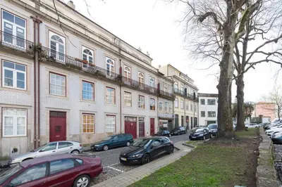 a group of cars parked in front of buildings at LovelyStay - The Porto Getaway Duplex - Free Parking in Porto