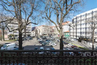 a view from a balcony of a parking lot with cars at LovelyStay - The Porto Getaway Duplex - Free Parking in Porto