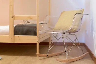 a chair sitting in front of a bunk bed at LovelyStay - The Porto Getaway Duplex - Free Parking in Porto