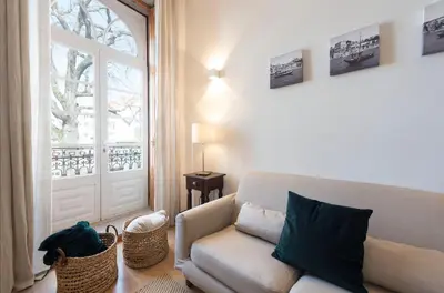 a living room with a couch and a window at LovelyStay - The Porto Getaway Duplex - Free Parking in Porto