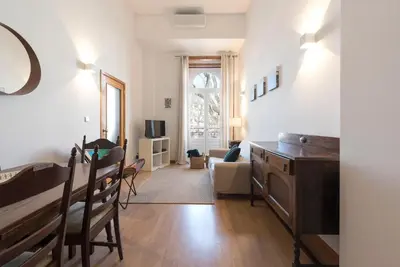 a living room with a table and a dining room at LovelyStay - The Porto Getaway Duplex - Free Parking in Porto