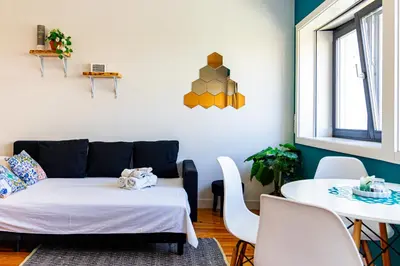 a living room with a couch and a table at Guest H4U - Porto Batalha City Center in Porto