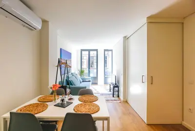 a dining room with a table and chairs at Oliveira Apartment`s in Porto