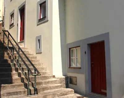 a building with stairs and a red door at Ribeira Cinema Apartments in Porto