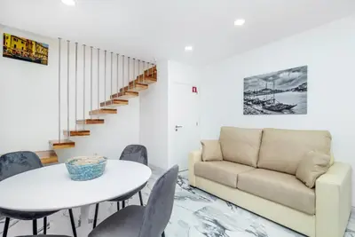 a living room with a couch and a table and chairs at Maredimo Village Porto Casa 2 in Porto