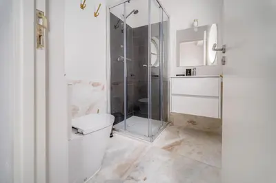a bathroom with a glass shower and a toilet at Nomad's By Sta Catarina Flats - 3BED Porto in Porto