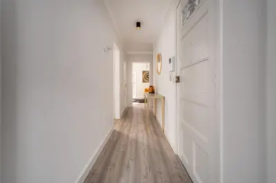 a hallway with white walls and a wooden floor at Nomad's By Sta Catarina Flats - 3BED Porto in Porto