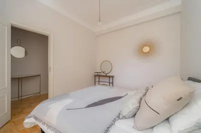 a white bedroom with a bed and a mirror at Nomad's By Sta Catarina Flats - 3BED Porto in Porto