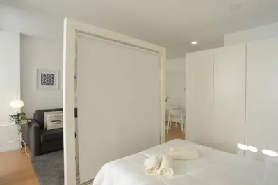 a bedroom with a bed with a large mirror at Softly Porto in Porto
