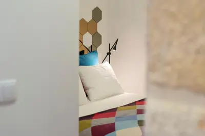 a white couch with pillows on it in a room at LovelyStay - Vitoria Viewpoint 1BR Flat in Porto