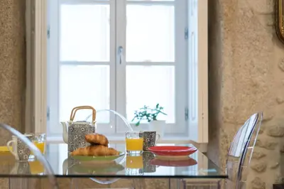 a glass table with a plate of food on it at LovelyStay - Vitoria Viewpoint 1BR Flat in Porto