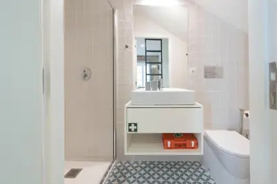 a white bathroom with a sink and a toilet at LovelyStay - Vitoria Viewpoint 1BR Flat in Porto