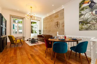 a living room with a table and chairs at Classy Belas Artes in Porto