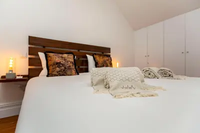 a bedroom with two beds with white sheets and pillows at Classy Belas Artes in Porto