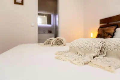 a white bed with two pillows on top of it at Classy Belas Artes in Porto