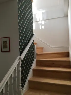 a stairway with a patterned wallpaper on the wall at Classy Belas Artes in Porto
