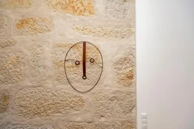 a clock on the side of a stone wall at Classy Belas Artes in Porto