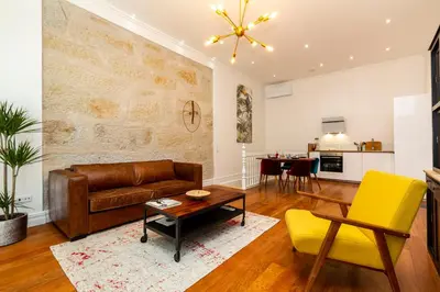 a living room with a couch and a table at Classy Belas Artes in Porto