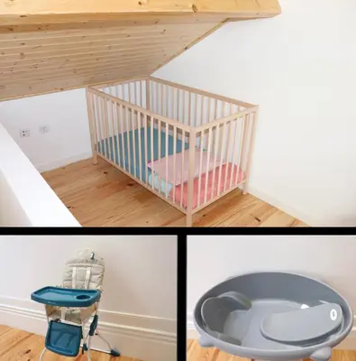 a room with a crib and a chair in a room at Porto Domus 210 Duplex in Porto