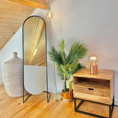 a mirror and a dresser in a room with a plant at Porto Domus 210 Duplex in Porto