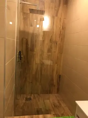 a shower with a glass door in a bathroom at City Heart Place 2 in Porto
