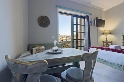 a dining room with a table and a bed and a window at MyRiverPlace N 4 Private Terrace River View Porto apartments in Vila Nova de Gaia