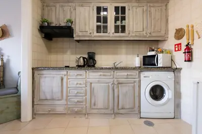 a kitchen with a washing machine and a microwave at MyRiverPlace N 4 Private Terrace River View Porto apartments in Vila Nova de Gaia