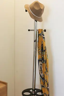 a cowboy hat and an umbrella on a stand at Trindade Family Apartment w/ Parking Place in Porto
