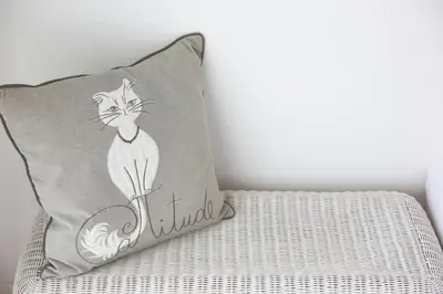 a pillow with a cat on it sitting on a bed at Trindade Family Apartment w/ Parking Place in Porto
