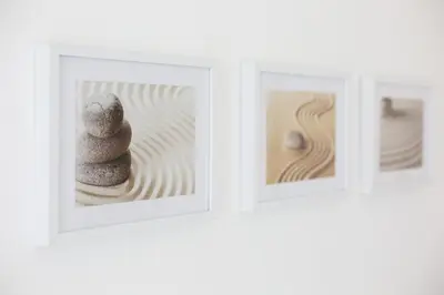 a group of three framed pictures of a pile of rocks at Trindade Family Apartment w/ Parking Place in Porto