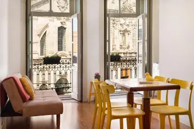 a dining room with a table and chairs and a window at Hungarian Biscuit Apartment in Porto