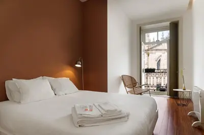 a bedroom with a bed with two towels on it at Hungarian Biscuit Apartment in Porto