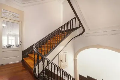 a spiral staircase with a round window in a building at Hungarian Biscuit Apartment in Porto