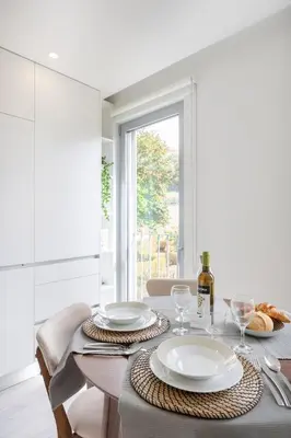 a white kitchen with a sink and a microwave at Modern Studio @ Palácio de Cristal in Porto