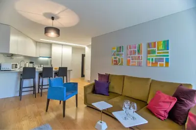 a living room with a couch and a kitchen at Premium Style Apt by Porto City Hosts in Porto