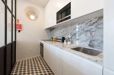 a kitchen with a sink and a counter at Quayside Douro River in Porto
