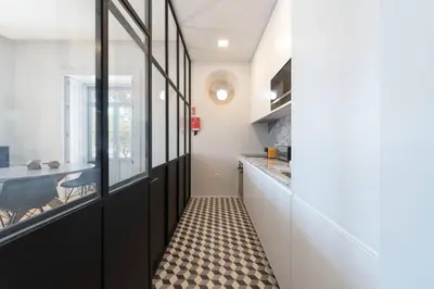 a kitchen with black doors and a checkered floor at Quayside Douro River in Porto