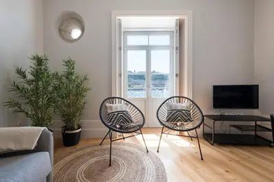 a living room with two chairs and a television at Quayside Douro River in Porto
