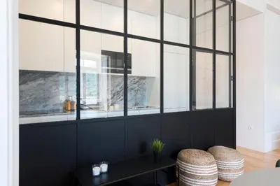 a living room with a large window and two stools at Quayside Douro River in Porto